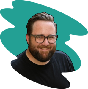 A person with a beard and glasses is smiling like a friendly local sherpa guide, set against a teal abstract background. They are wearing a black shirt.